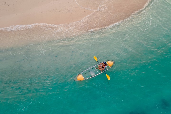 a man riding a wave on a surfboard in the water